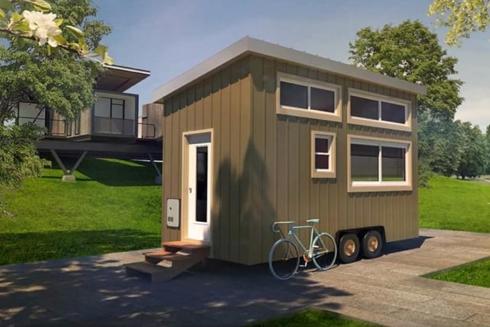 A mini home with a bicycle parked in front, available for sale.