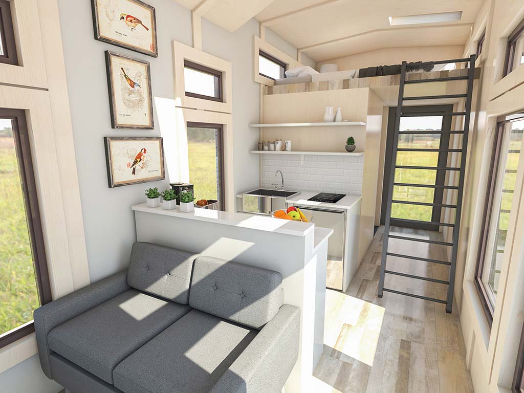 The interior of a custom tiny house with a couch and stairs.
