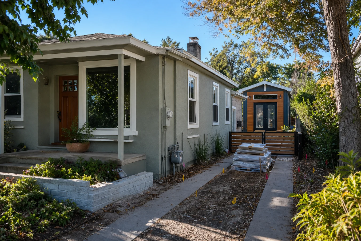ADU builders Fern Hill backyard tiny house feasibility scene with side access, utility meters, survey flags, and compact detached ADU