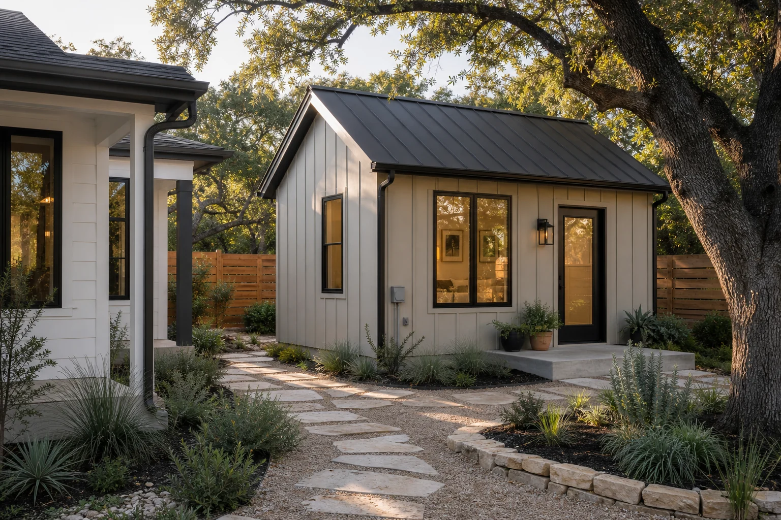Austin backyard ADU beside a primary home with live oak trees and native landscaping