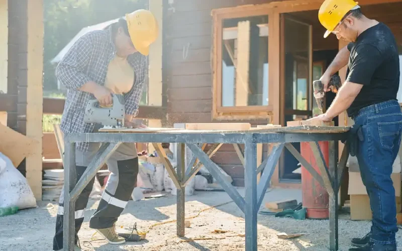 Workers preparing a garage conversion before turning the space into a living area