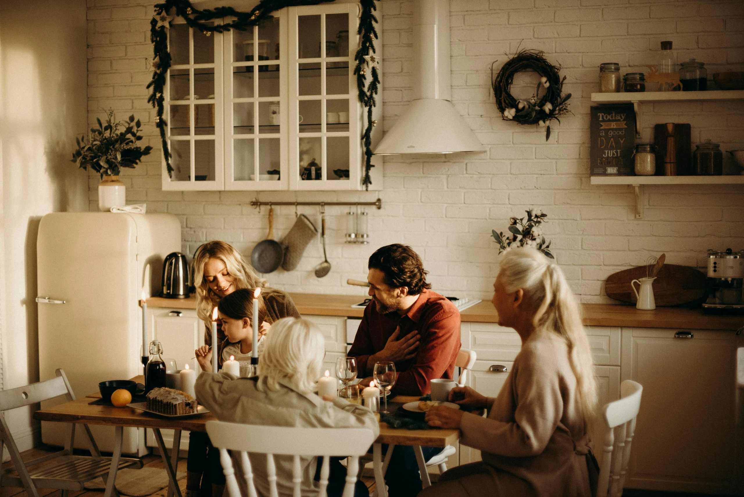 Family gathered in a compact kitchen showing practical family home daily living
